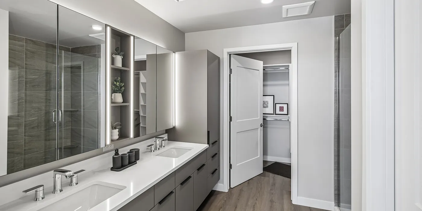Spa-inspired bathroom at The Astrie with double vanity and oversized closet