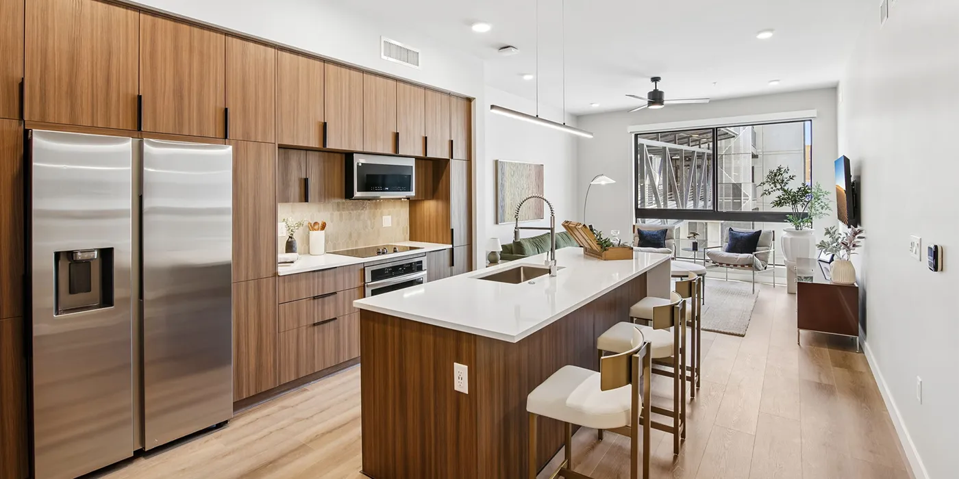 Open-concept residence at The Astrie with contemporary kitchen and naturally lit living space
