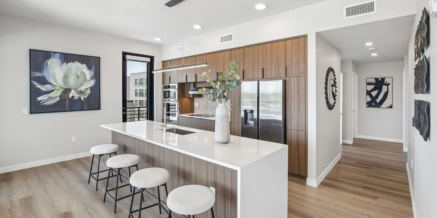Contemporary kitchen at The Astrie with quartz island and modern wood cabinetry