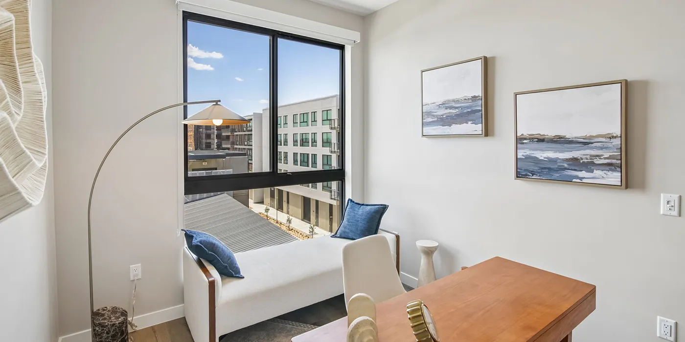 Modern home office at The Astrie with natural light and expansive windows