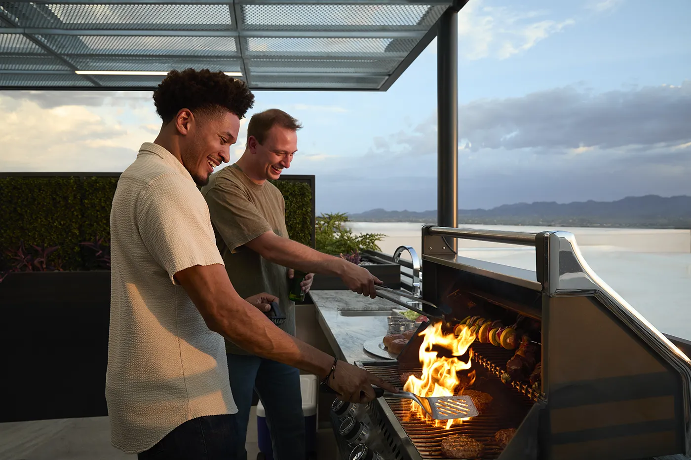 The Astrie residents grilling on a rooftop terrace with Tucson mountain views