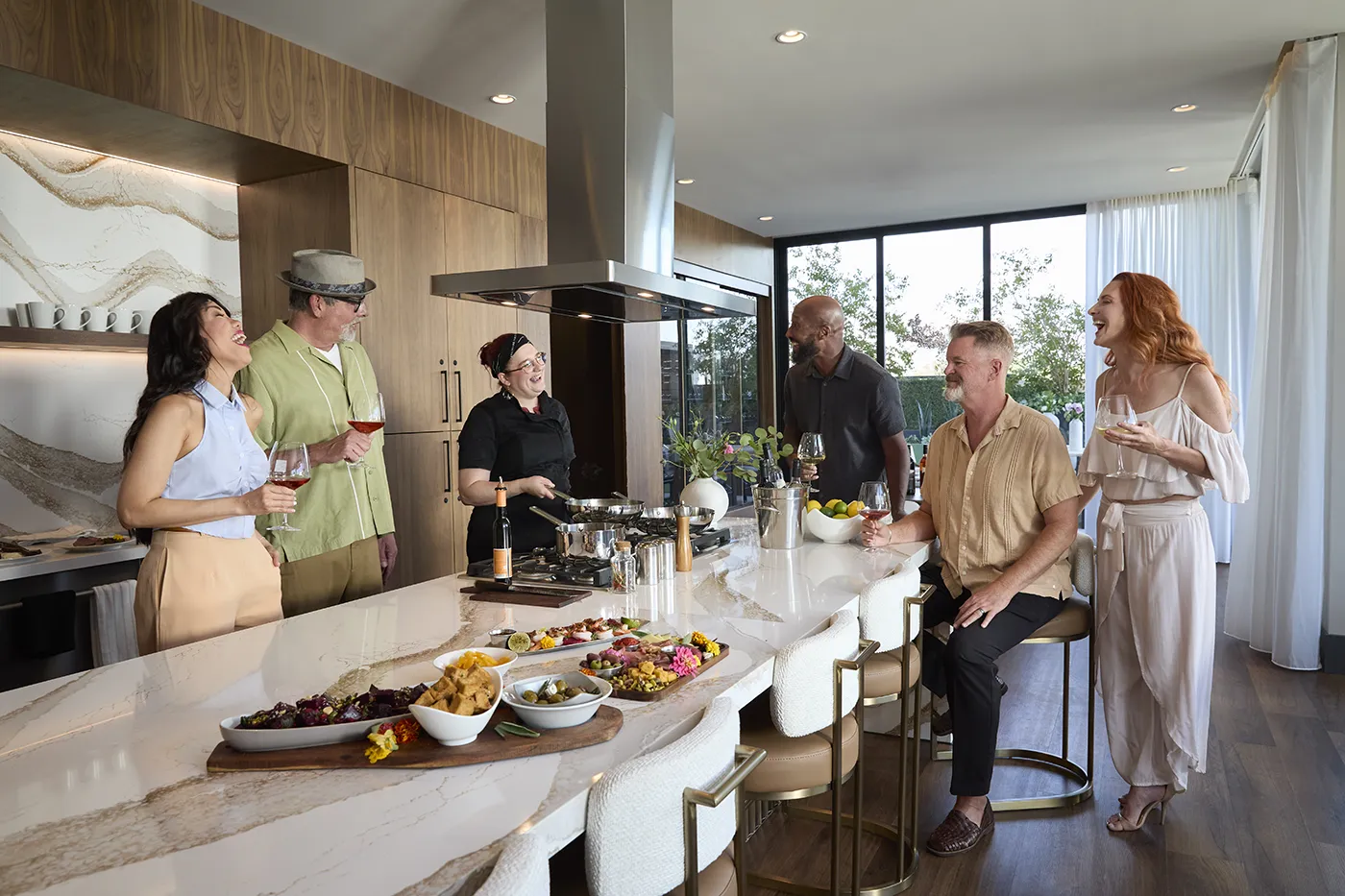 The Astrie residents gathering for a private dining experience in a luxury community kitchen