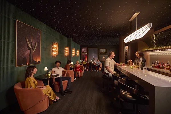 The Astrie residents enjoying drinks in the intimate speakeasy lounge